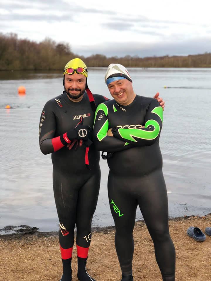 Two people in full cold weather swimming gear